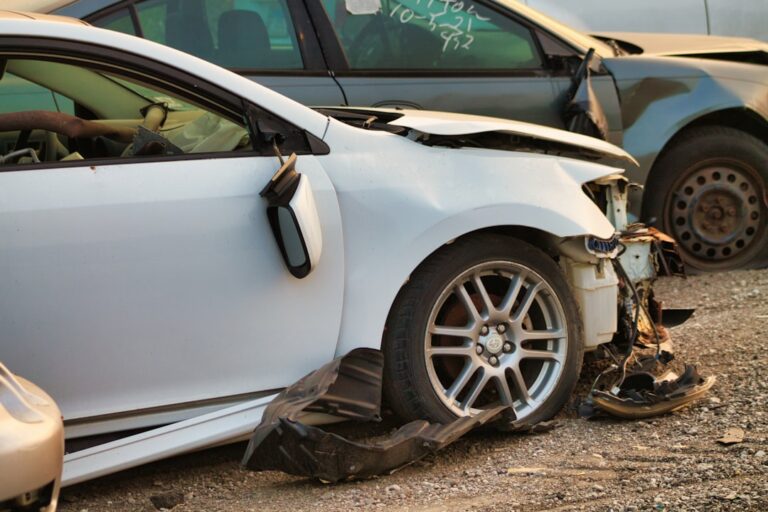 A person carefully inspecting a car’s door and taking close-up photos of scratches after shipping.